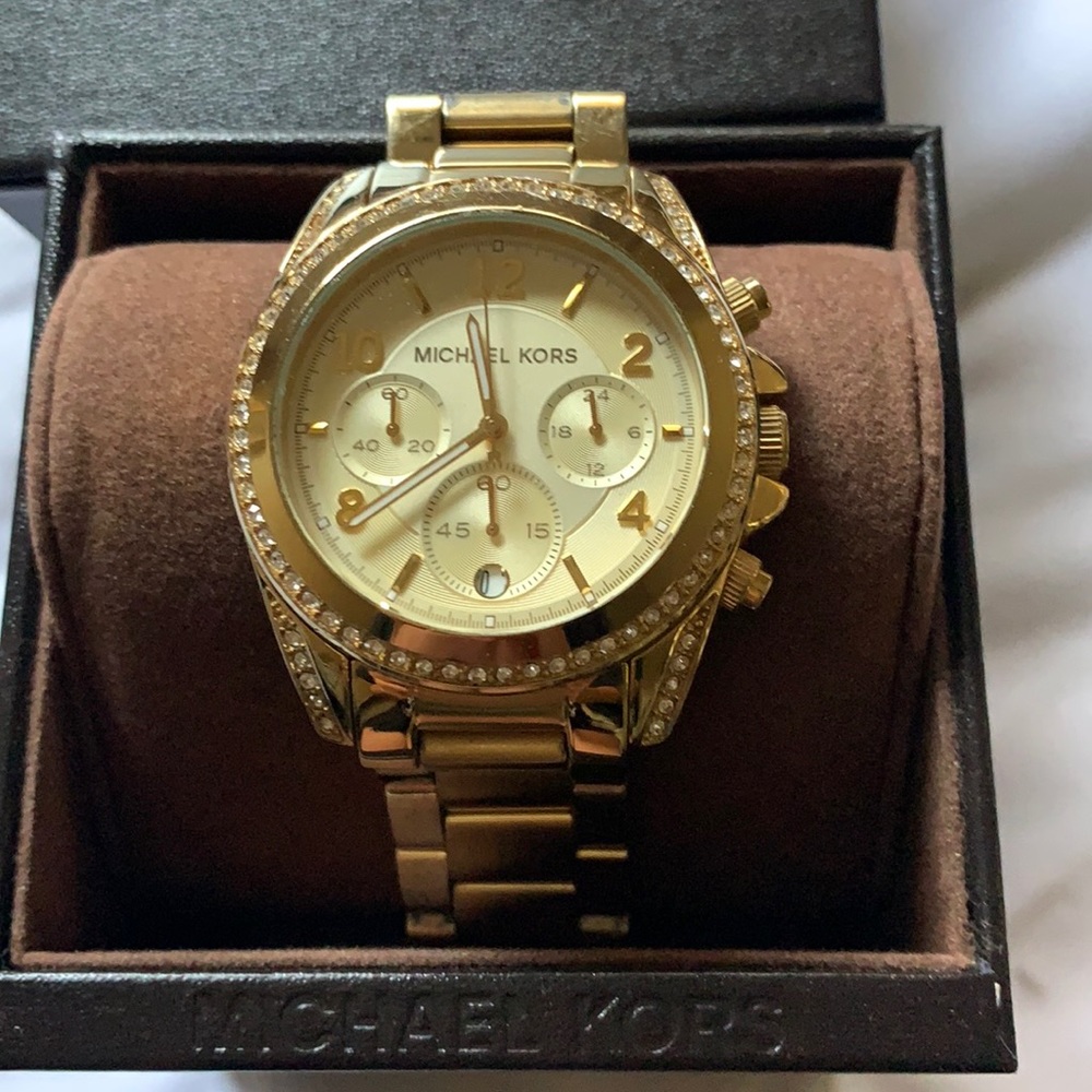 Gold Watch with stone detailing around the face